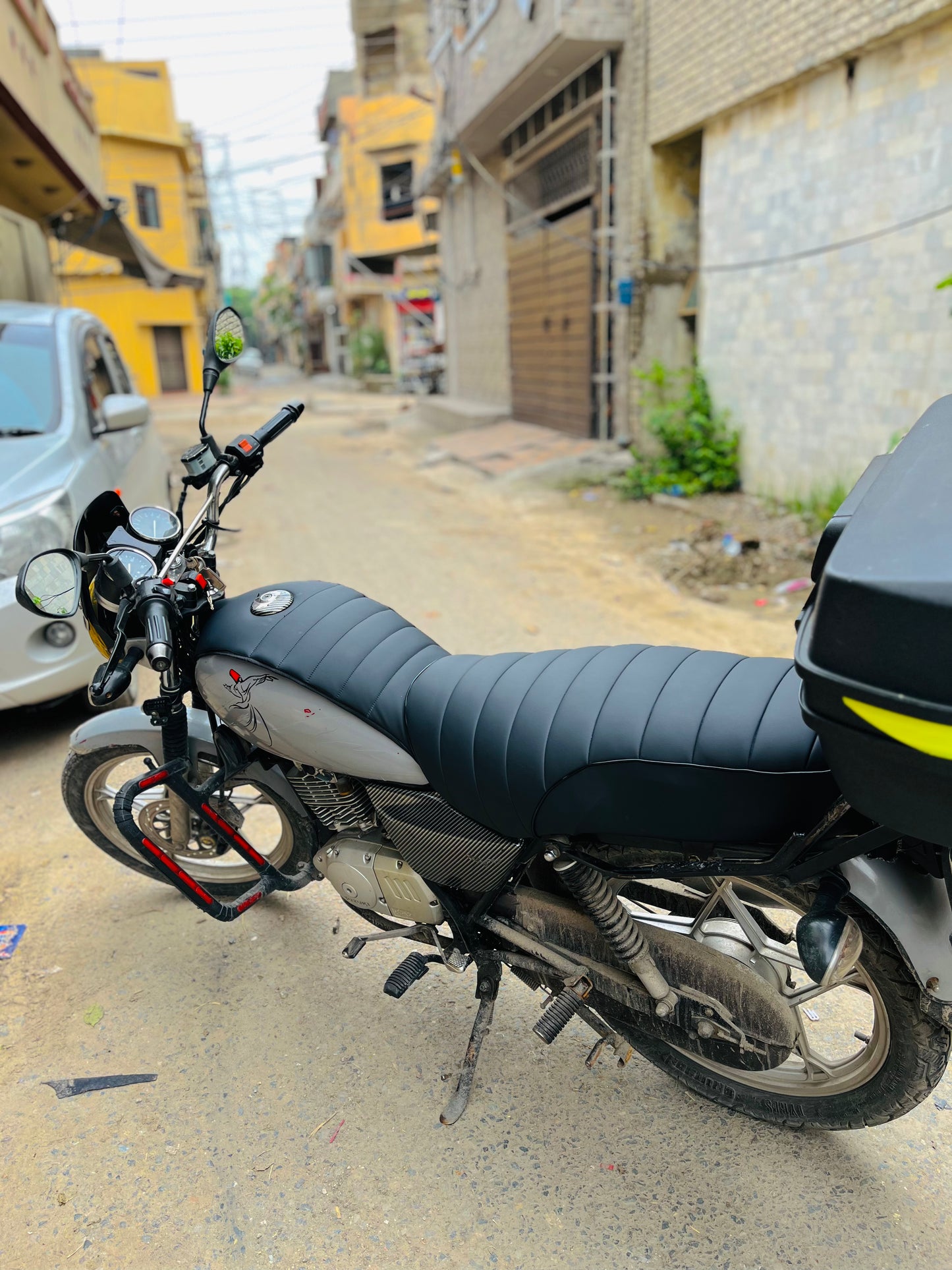 Motorcycle parked on a street with buildings in the background